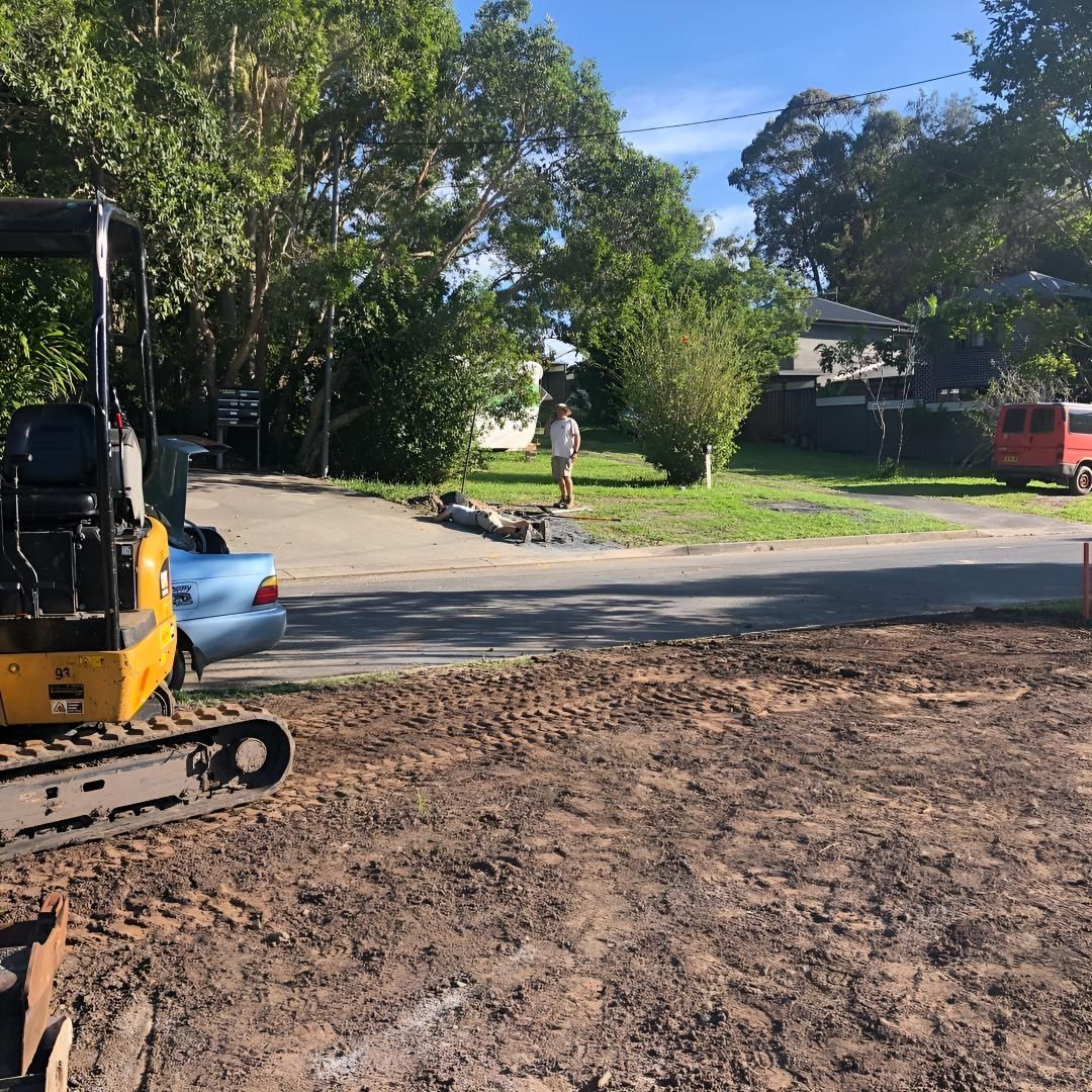 A Yellow Excavator is Parked on the Side of a Dirt Road — Limited Access Excavation In Suffolk Park, NSW