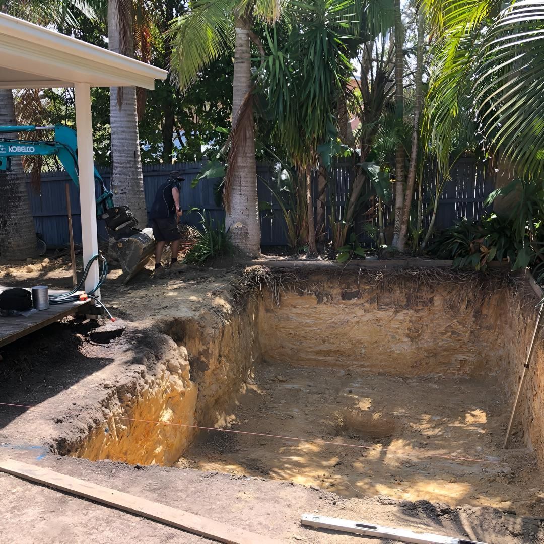 A Man is Digging a Hole in the Ground to Build a Pool — Limited Access Excavation In Suffolk Park, NSW