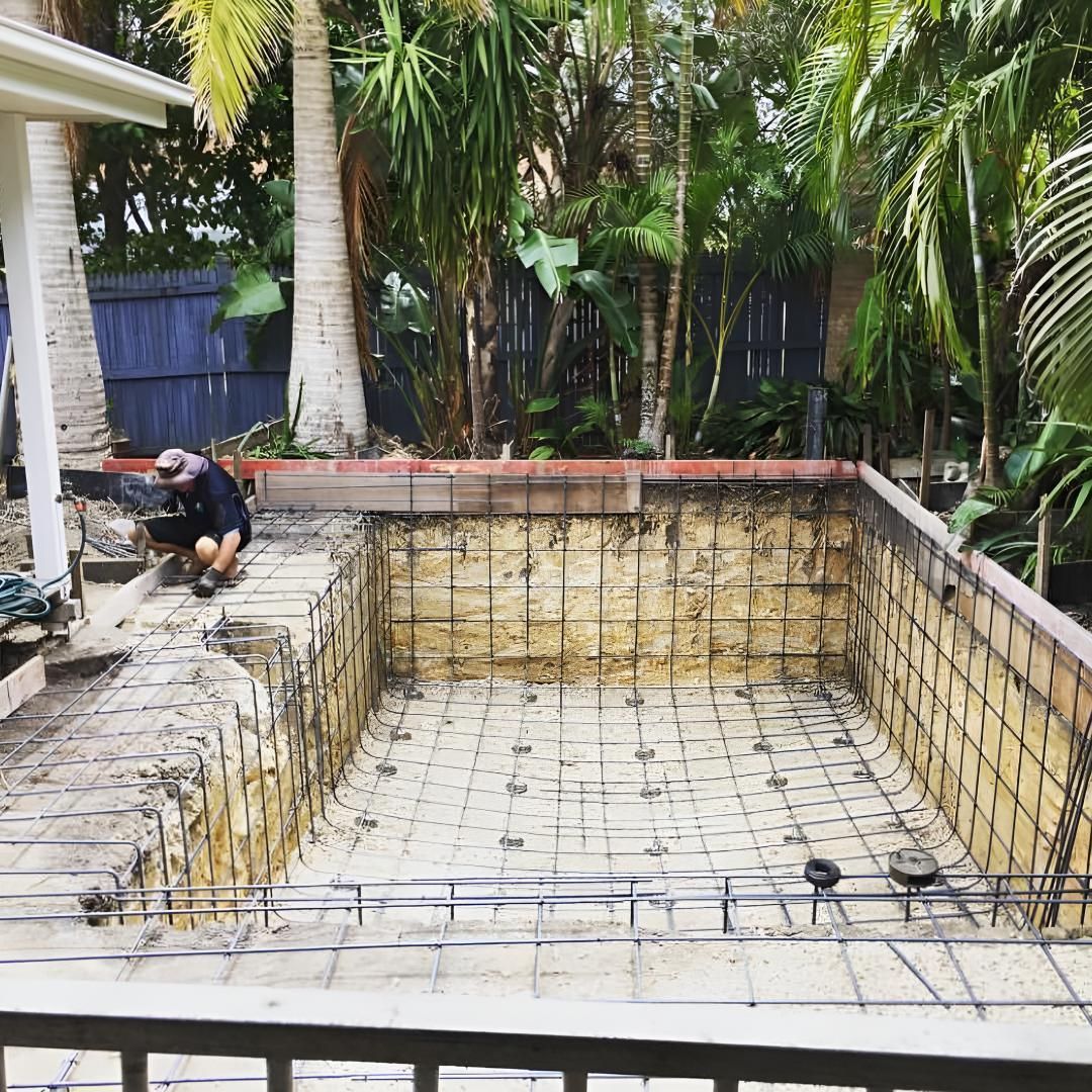 A Man is Working on a Swimming Pool in a Backyard. — Limited Access Excavation In Tweed Heads, NSW