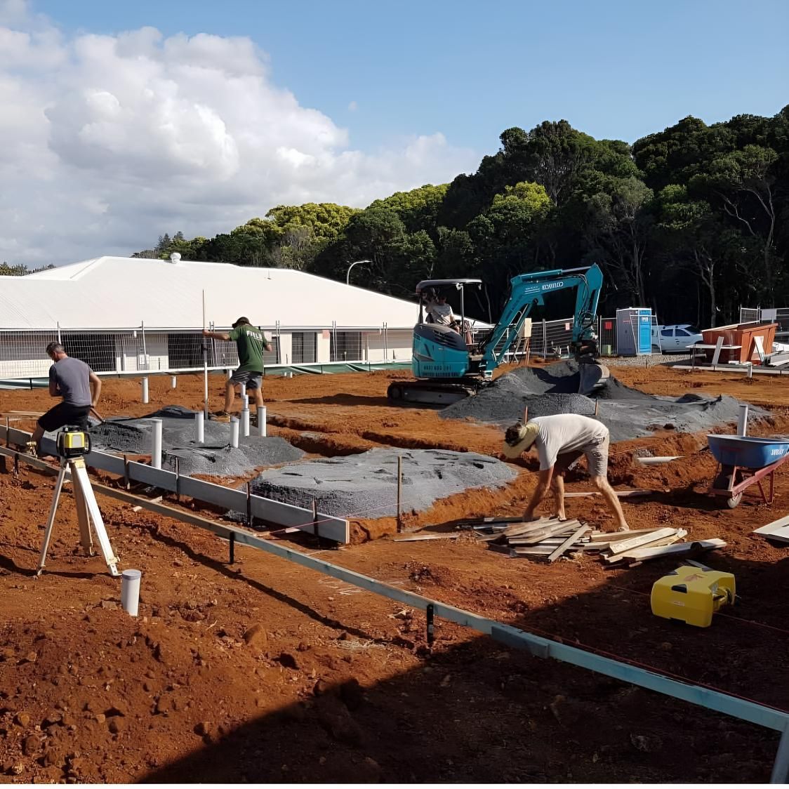 A Construction Site With a Blue Excavator in the Background — Limited Access Excavation In Mullumbimby, NSW