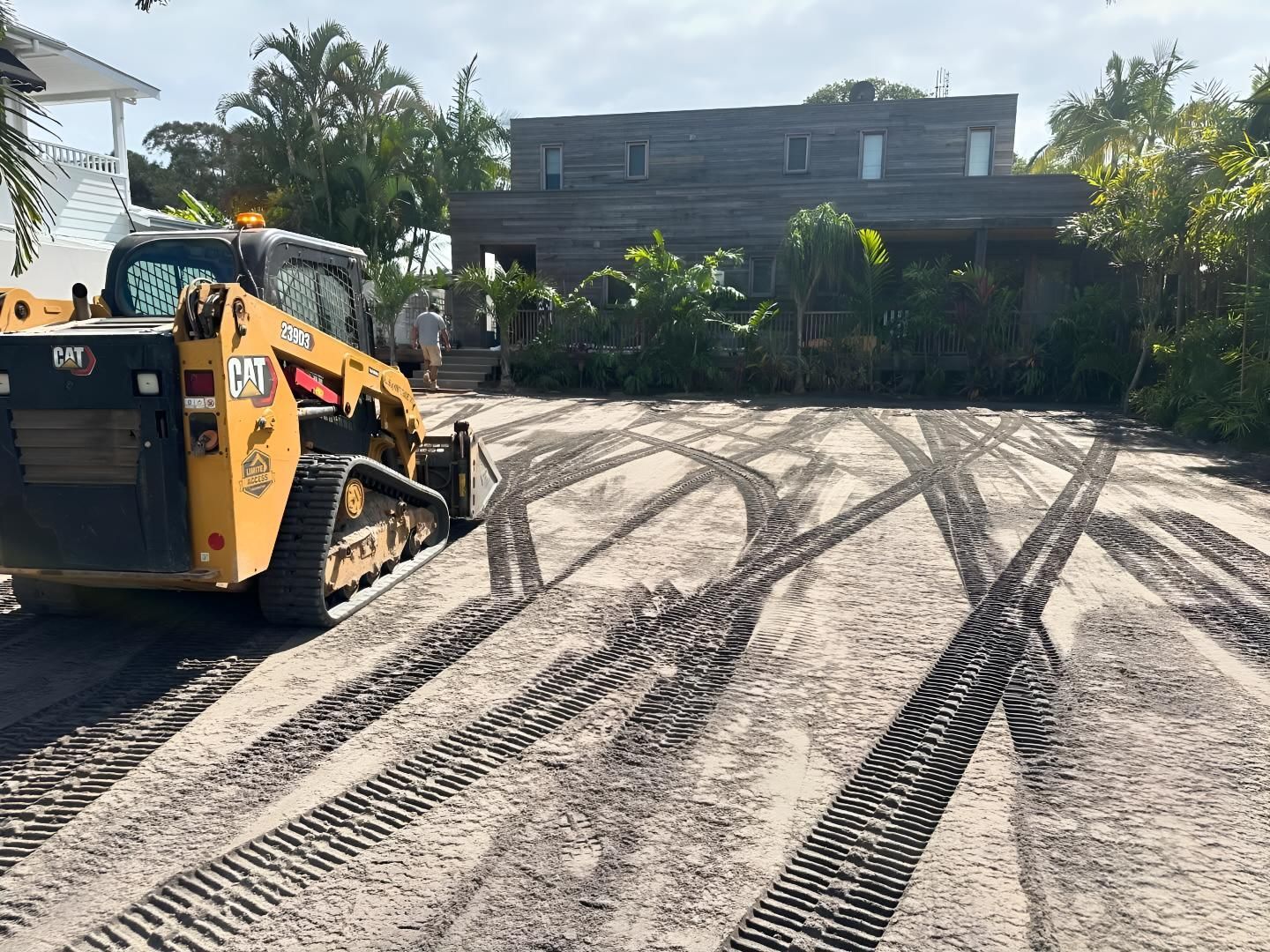A Bulldozer is Moving Dirt in Front of a House — Limited Access Excavation In Suffolk Park, NSW