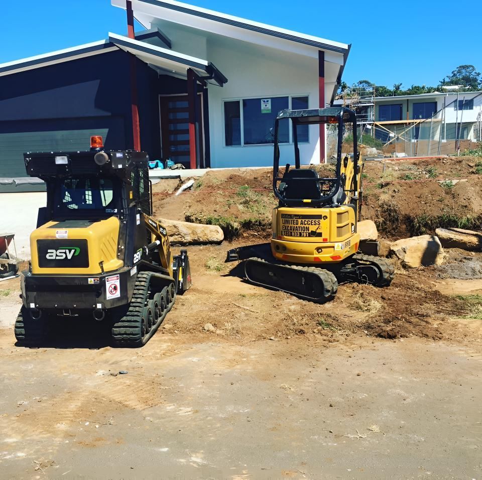 A Yellow ASV Tractor is Parked in Front of a House — Limited Access Excavation In Suffolk Park, NSW