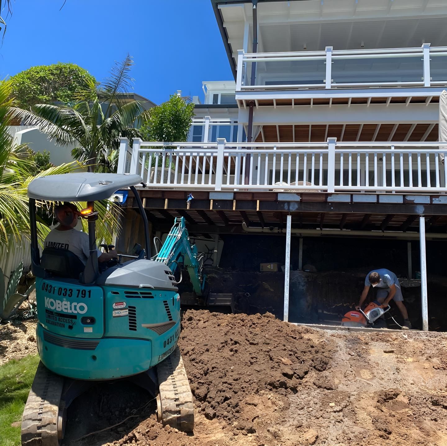 A Kobelco Excavator is Parked in Front of a House — Limited Access Excavation In Grafton, NSW