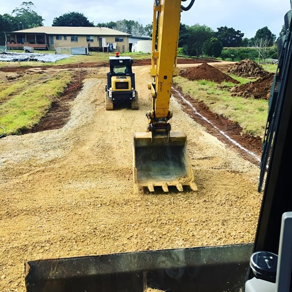 A Yellow Excavator is Moving Dirt on a Dirt Road — Limited Access Excavation In Murwillumbah, NSW
