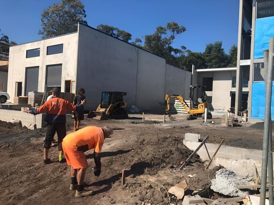 A Group of Construction Workers Are Working on a Construction Site in Front of a Building — Limited Access Excavation In Mullumbimby, NSW