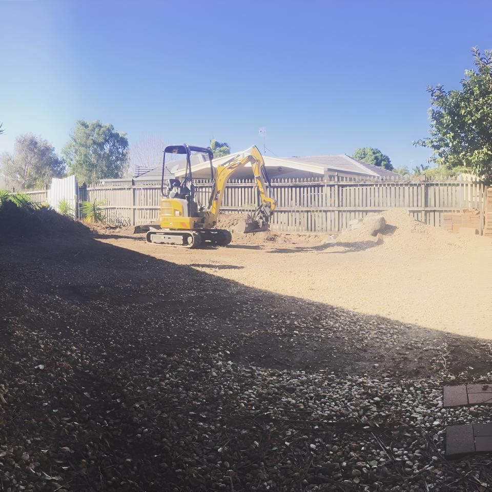A Yellow Excavator is Digging in a Dirt Field in Front of a House — Limited Access Excavation In Suffolk Park, NSW