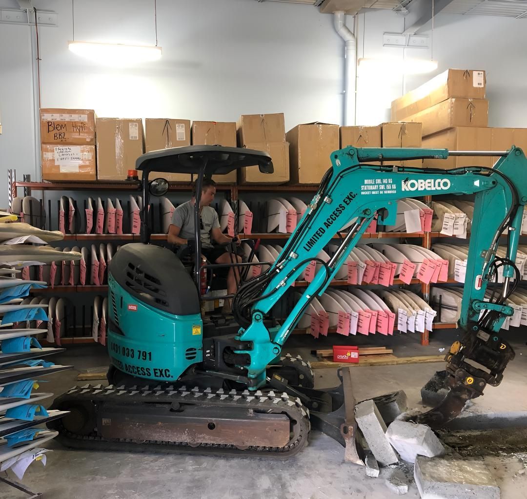 A Kobelco Mini Excavator is Parked in a Warehouse — Limited Access Excavation In Suffolk Park, NSW