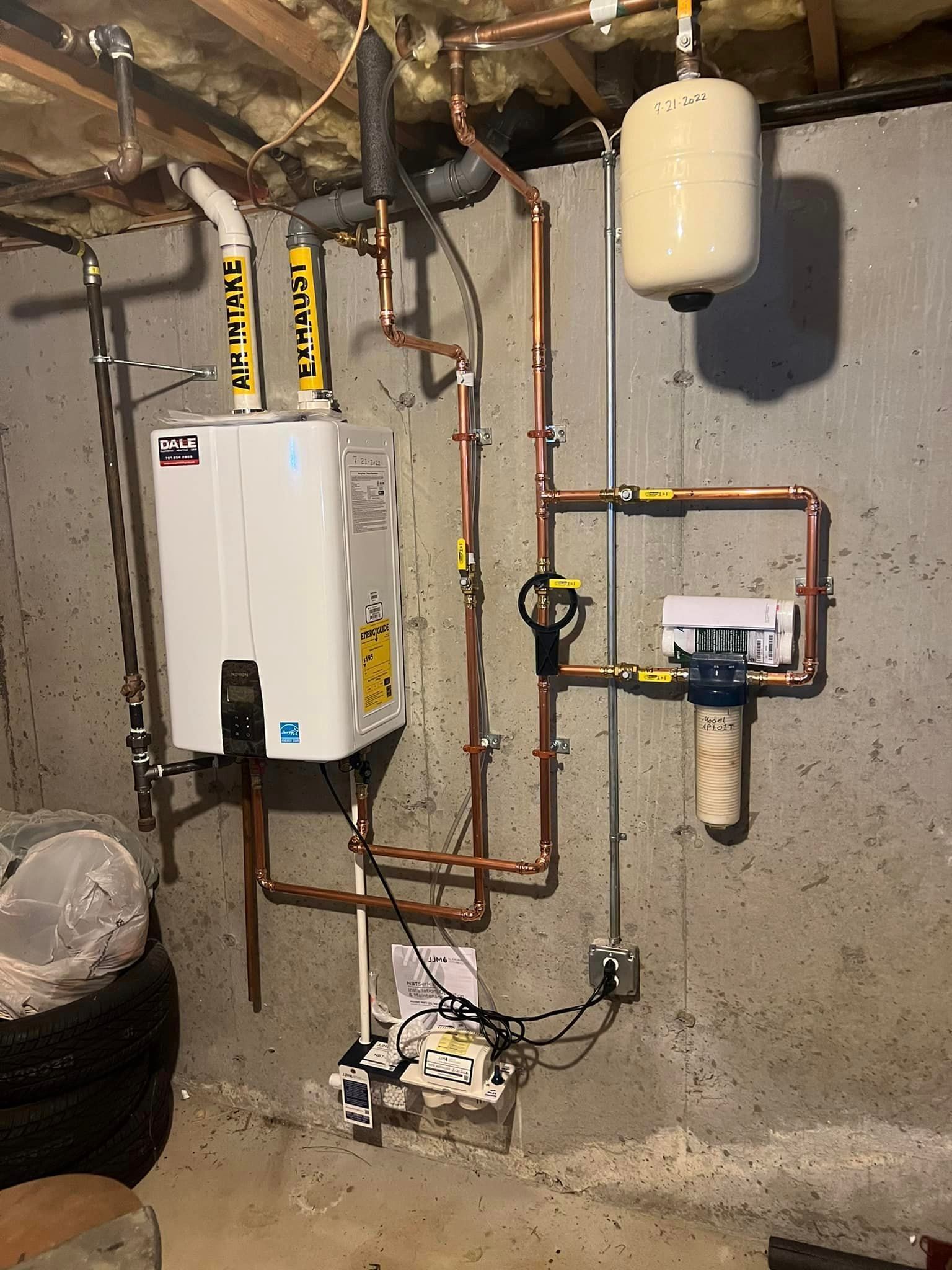 a water heater is installed in a basement with copper pipes .