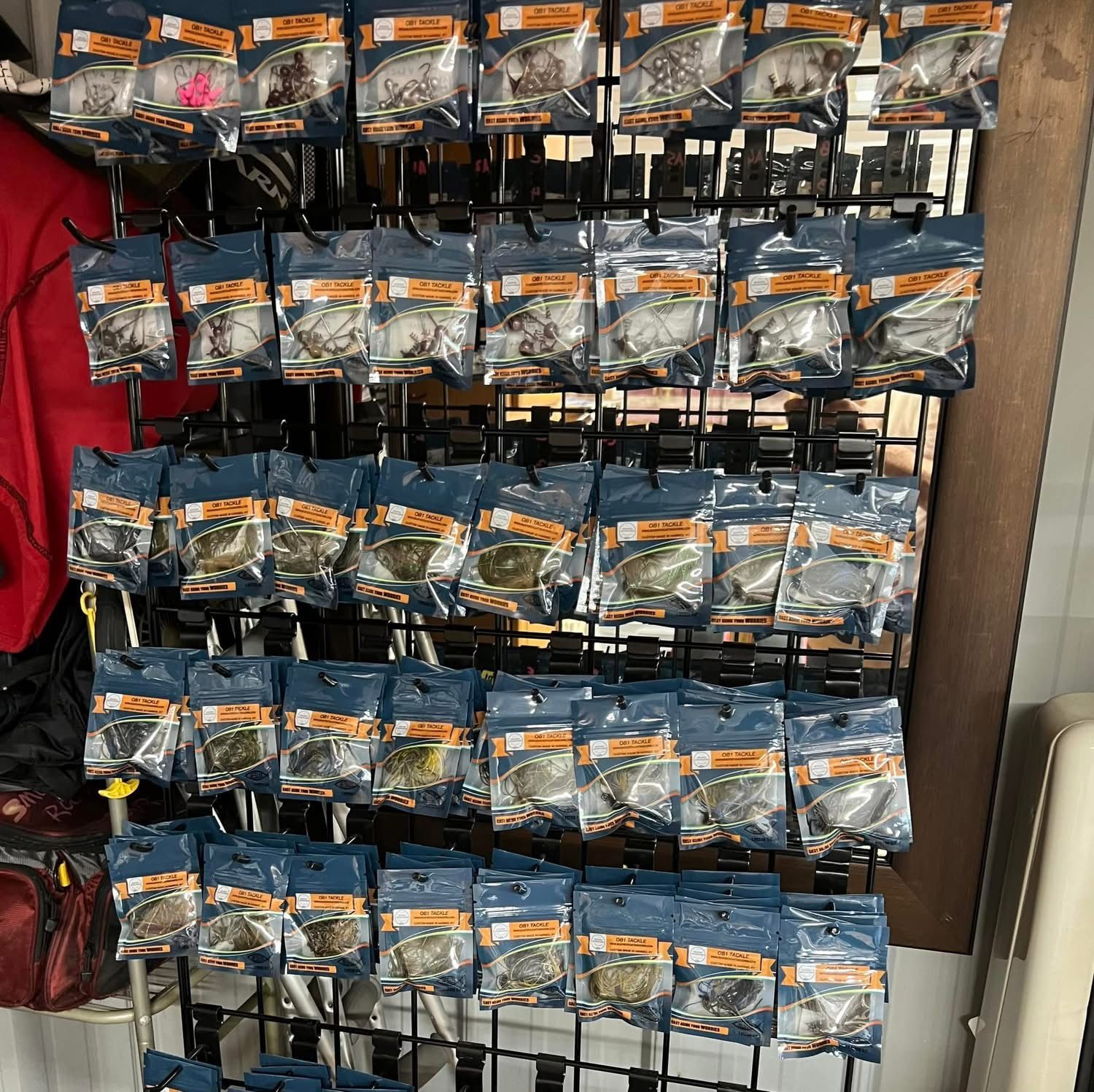 Rows of custom fishing lures in brown, green, and blue, displayed under 