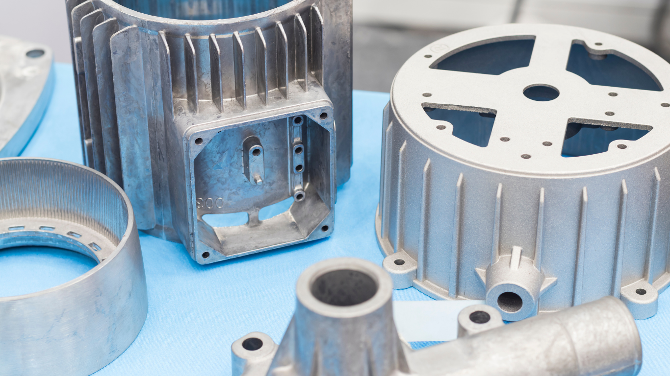 Molten metal pouring from a crucible, controlled by a worker using a large wheel in a factory setting.