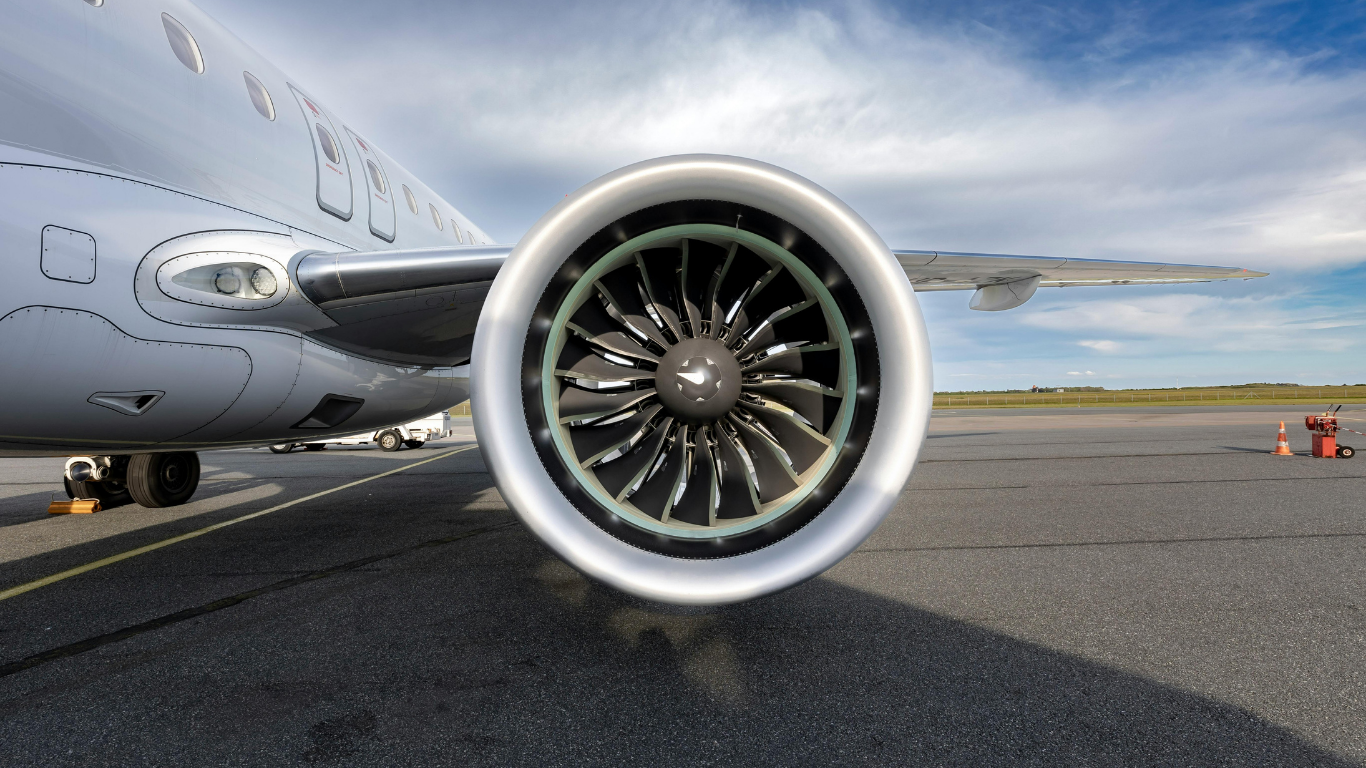 Molten metal pouring from industrial furnace, glowing orange in a factory setting.