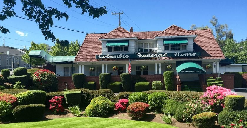 Exterior of Columbia Funeral Home with landscaped gardens and welcoming entrance, representing trusted Mercer Island, WA funeral home and cremations services.