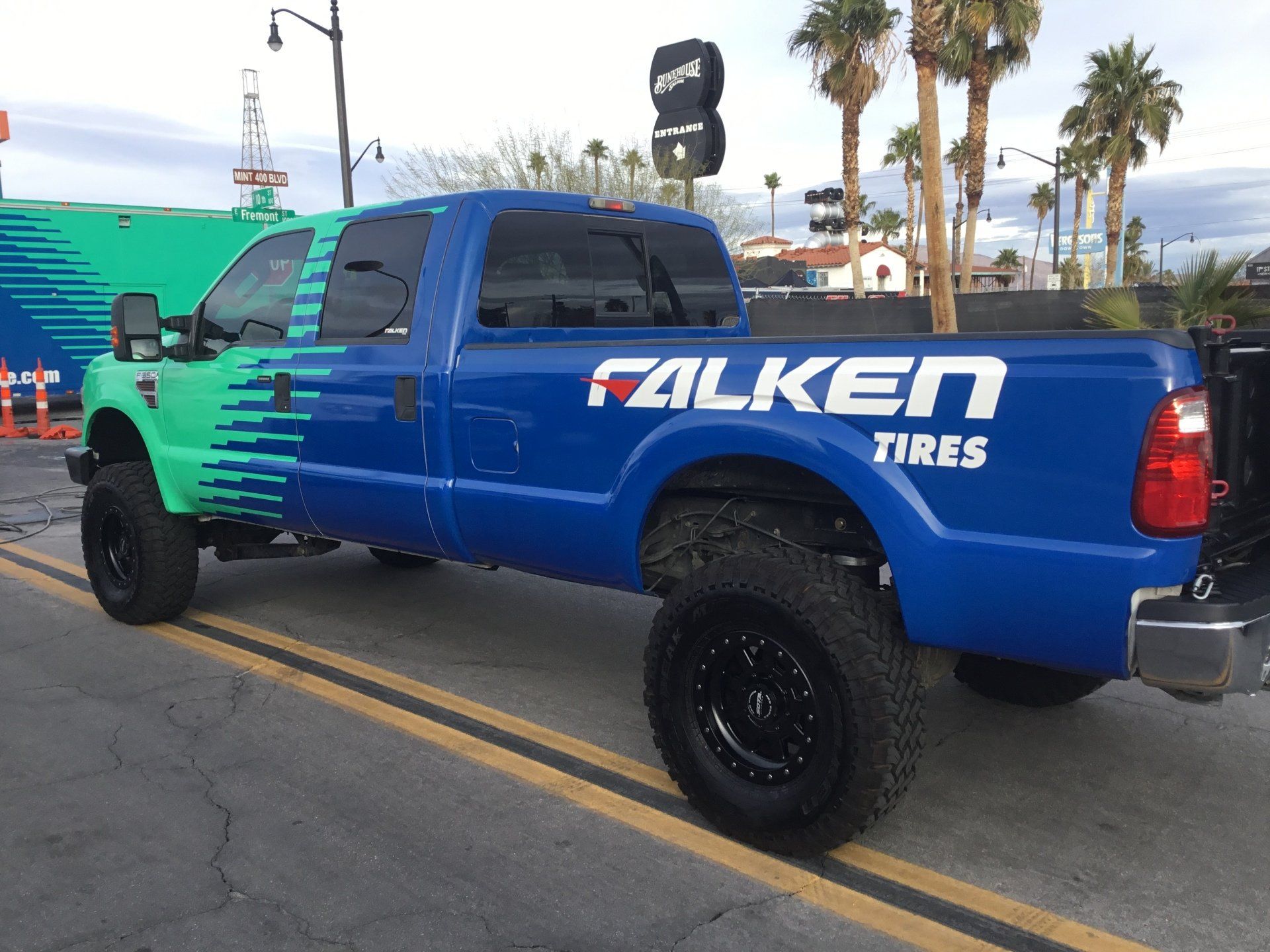 A blue truck with the word falken tires on the back