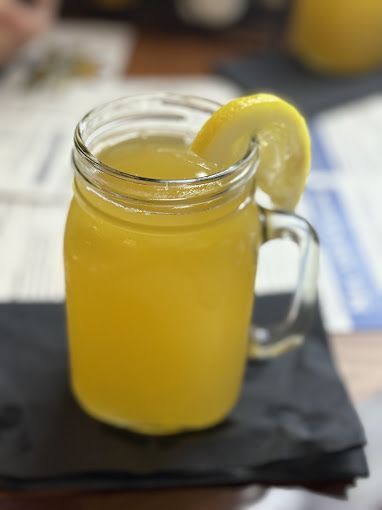 A plate of food with a sandwich and tots on it