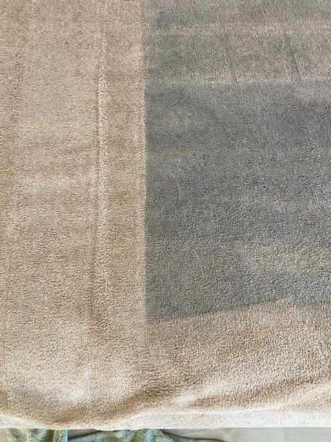 Close-up of beige and gray fabric with a subtle woven texture and seam detail