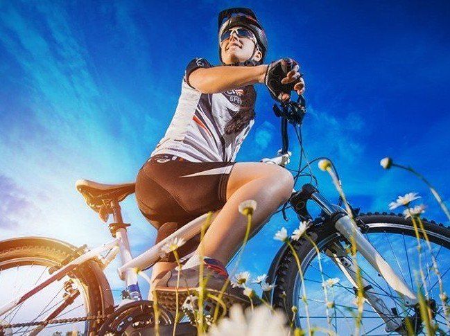 Woman on mountain bike, symbolizing benefits of borealis therapy in Anchorage, AK.