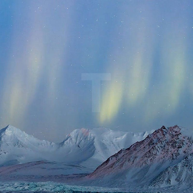 Northern lights about snowcapped mountains. Borealis Therapy helps you get out there!