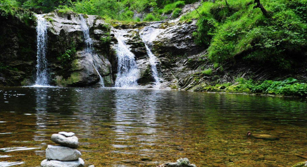 Person walking on mountain ridge, representing rolfing benefits.