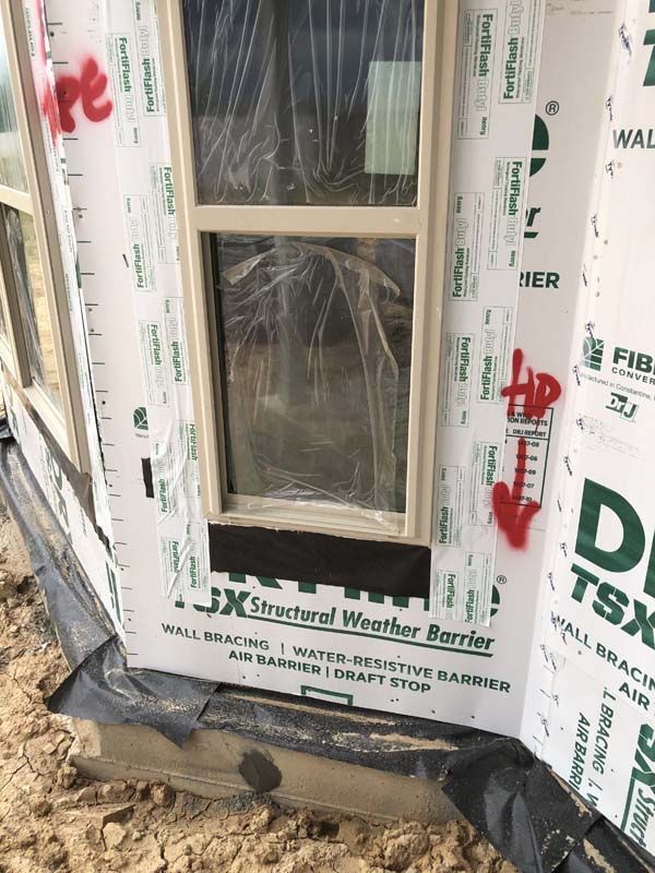 A door with a structural weather barrier on it is being built.