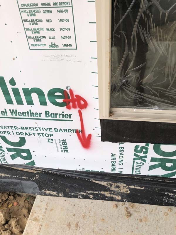 A window with a line to weather barrier on it
