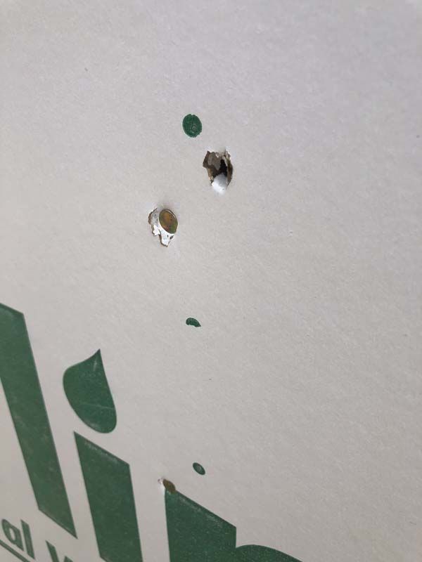 A close up of a cardboard box with holes in it