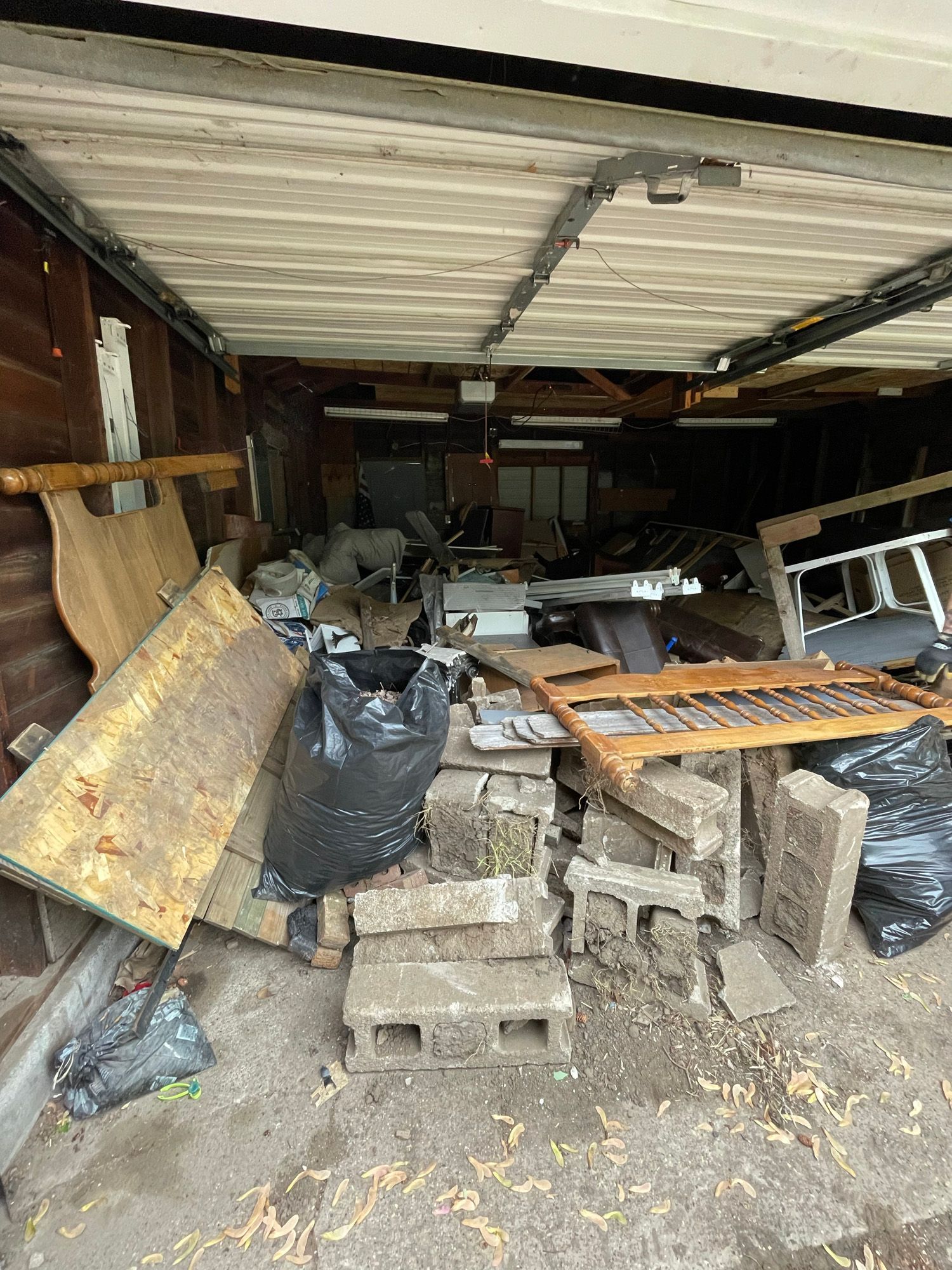 A garage filled with lots of trash and junk.