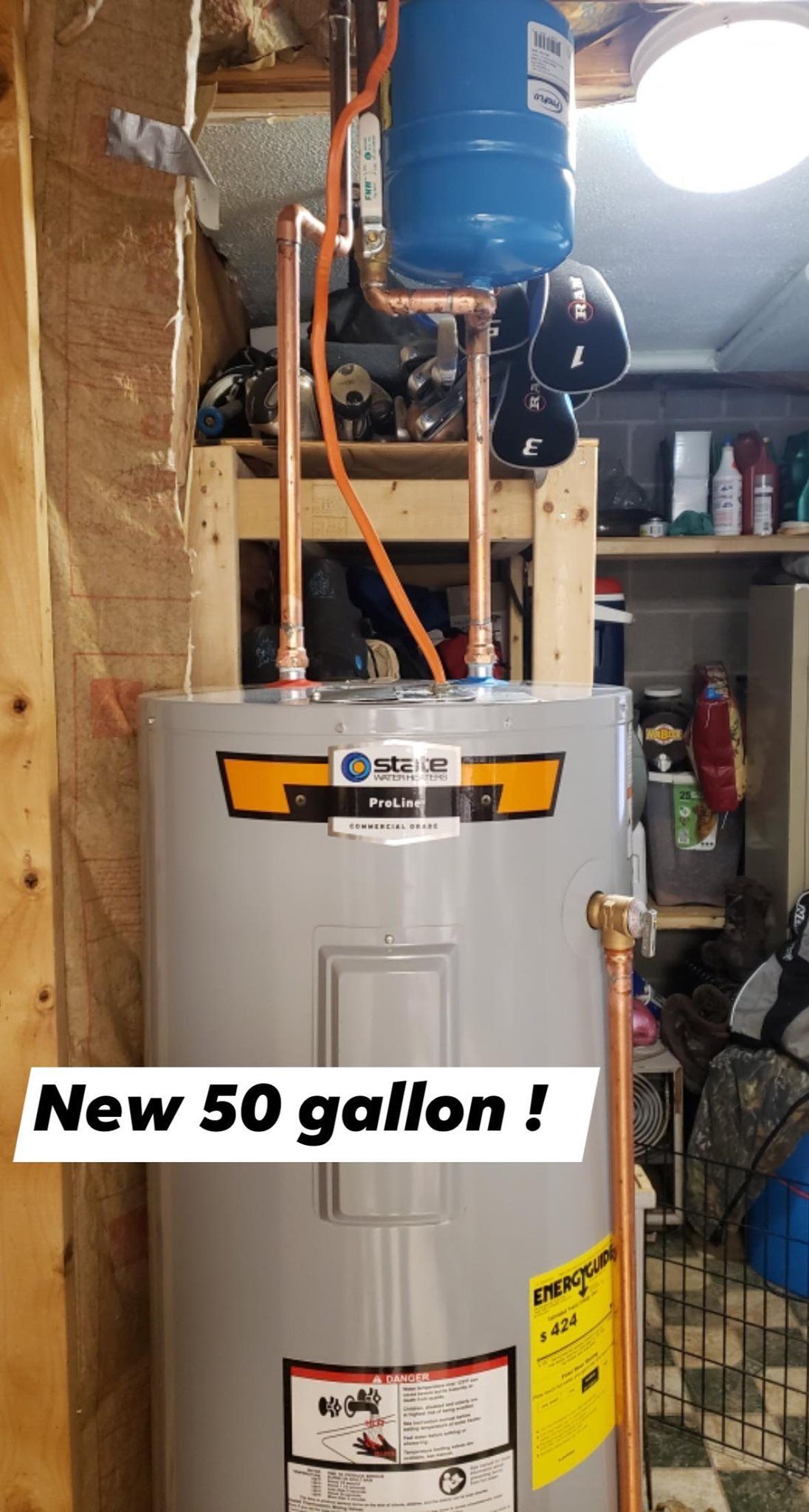 a new 50 gallon water heater is being installed in a garage .