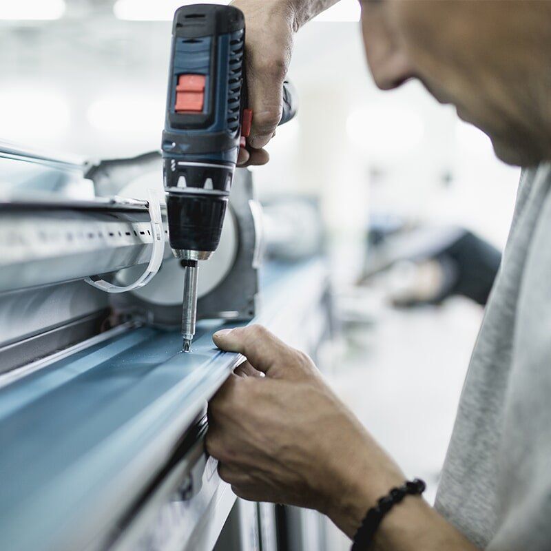 Man Making an Aluminium Window For Installation — Glass & Aluminium in Emerald, QLD