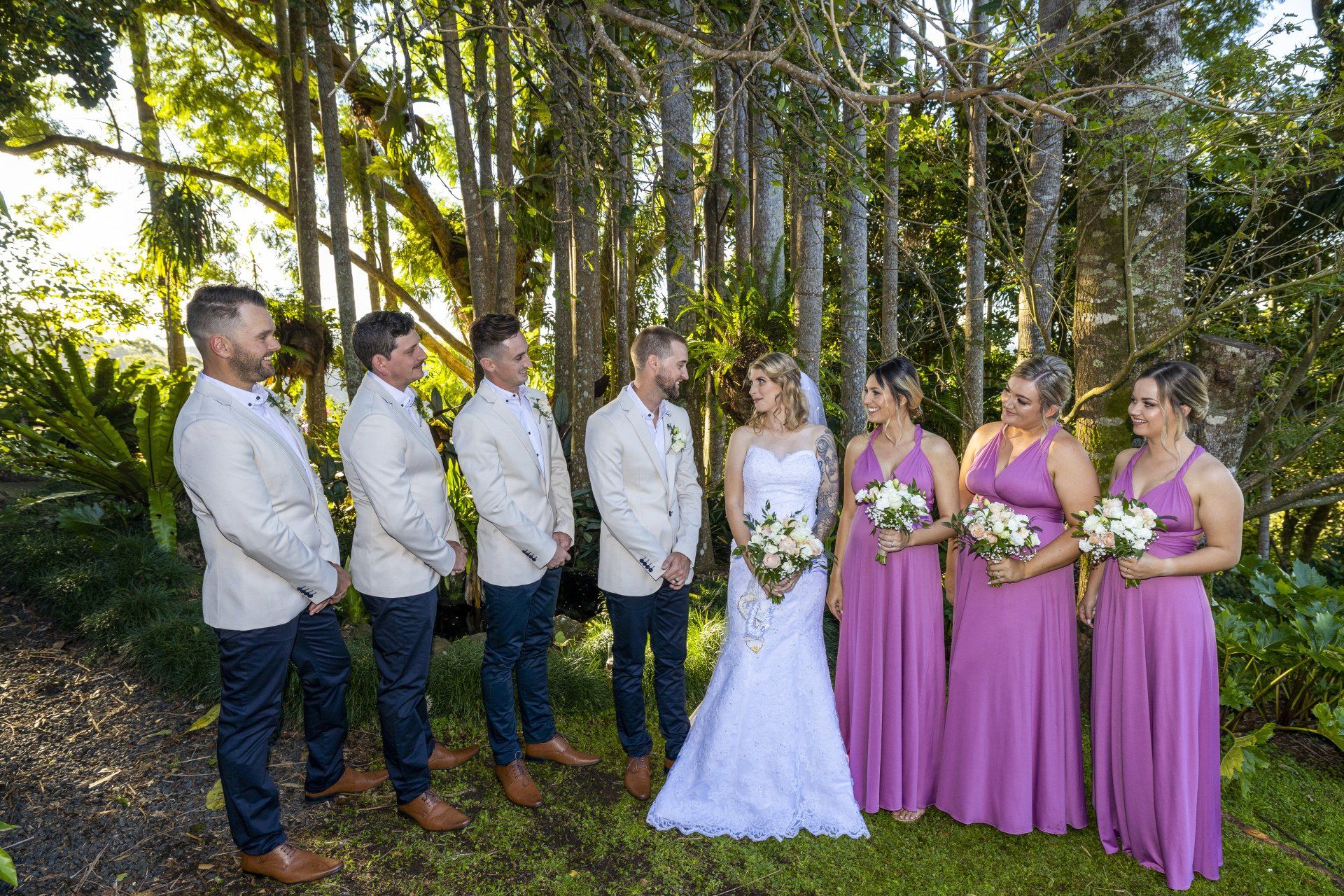 a bride and groom are posing for a picture with their wedding party .