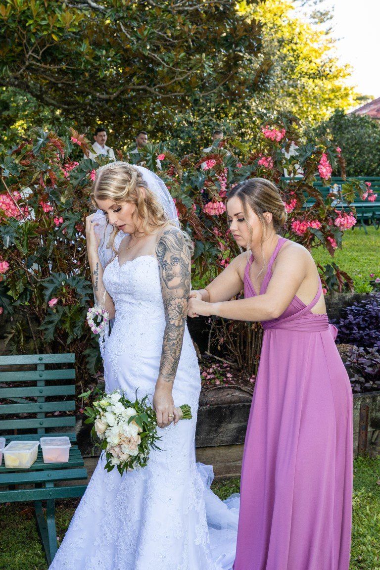 a bride is getting ready for her wedding with her bridesmaid .