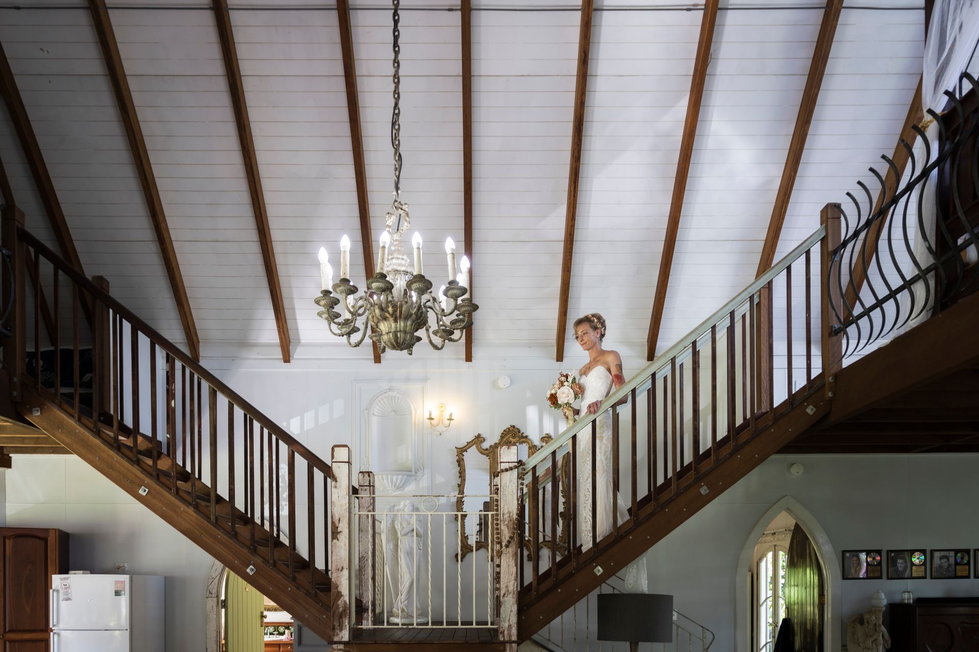 a bride is standing on the stairs of a house .