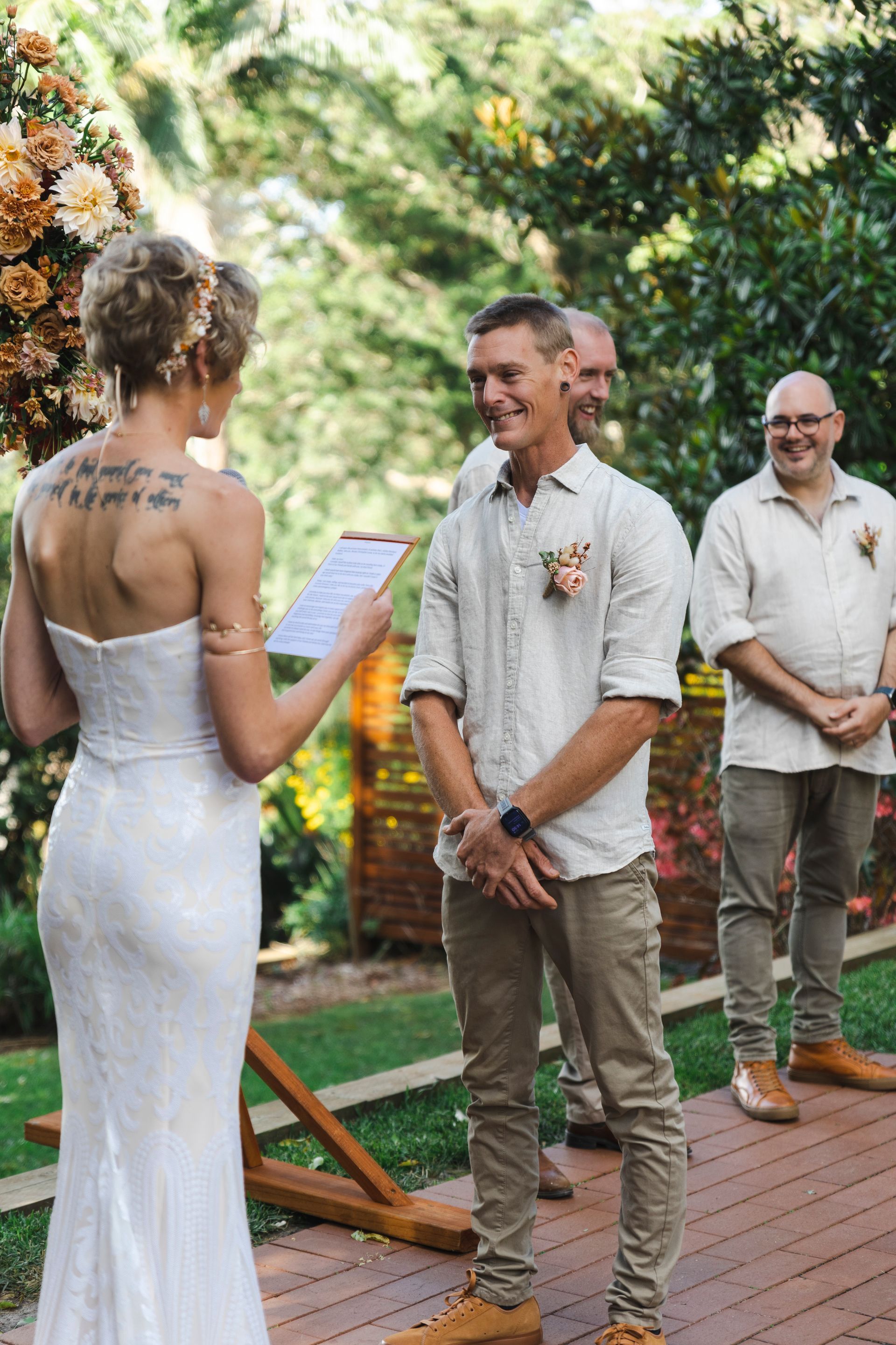 a bride and groom are standing next to each other during a wedding ceremony .