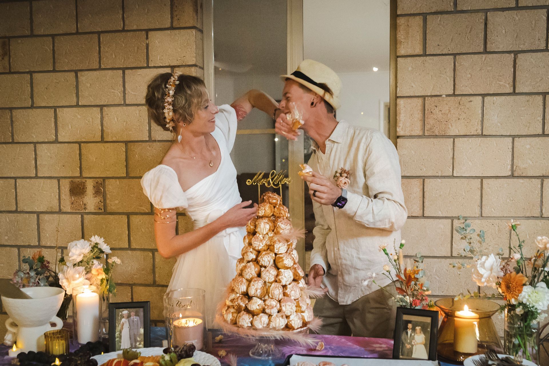 Wedding cake - a bride and groom are kissing in front of a wedding cake .