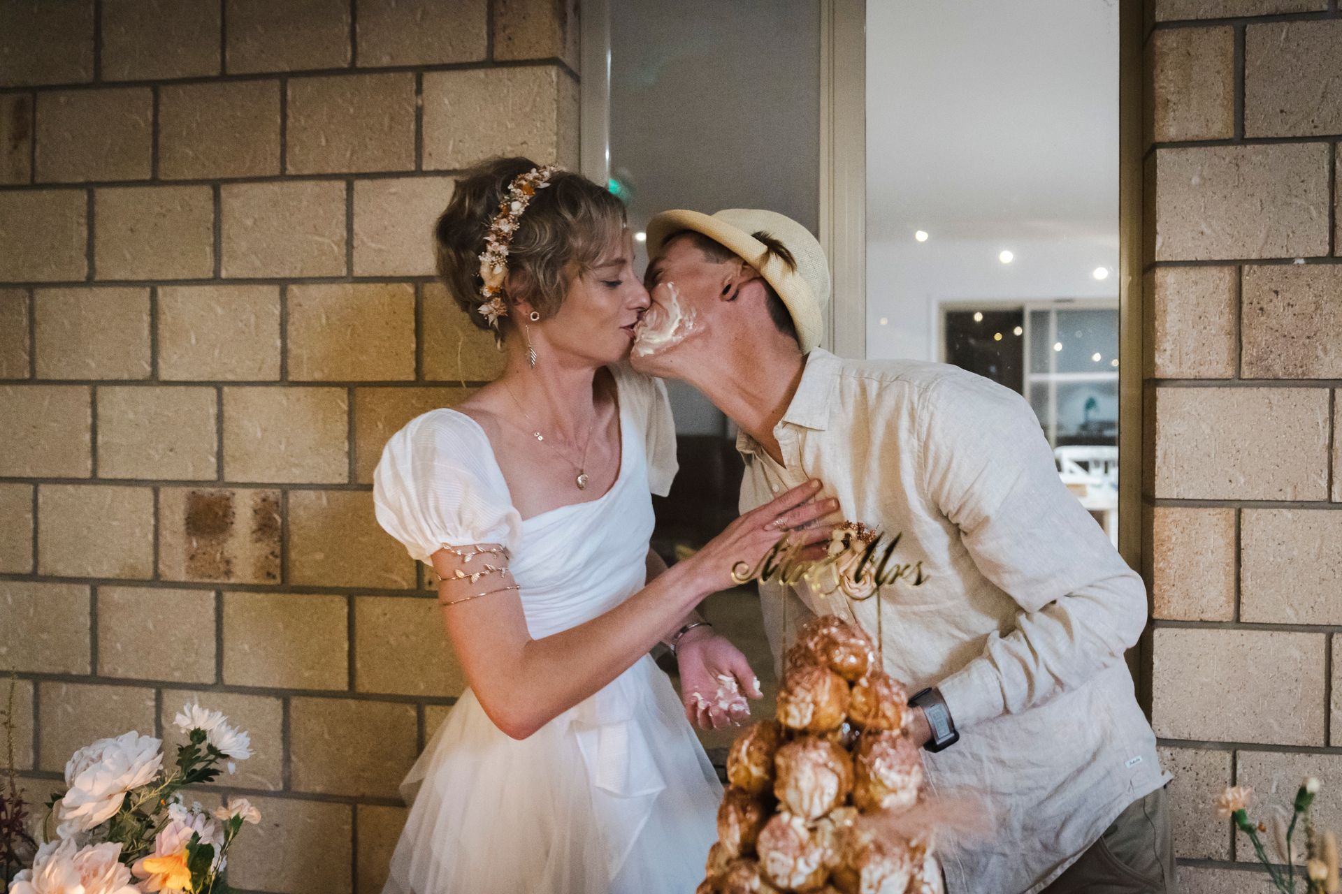 Wedding cake - a bride and groom are kissing after cutting their wedding cake .