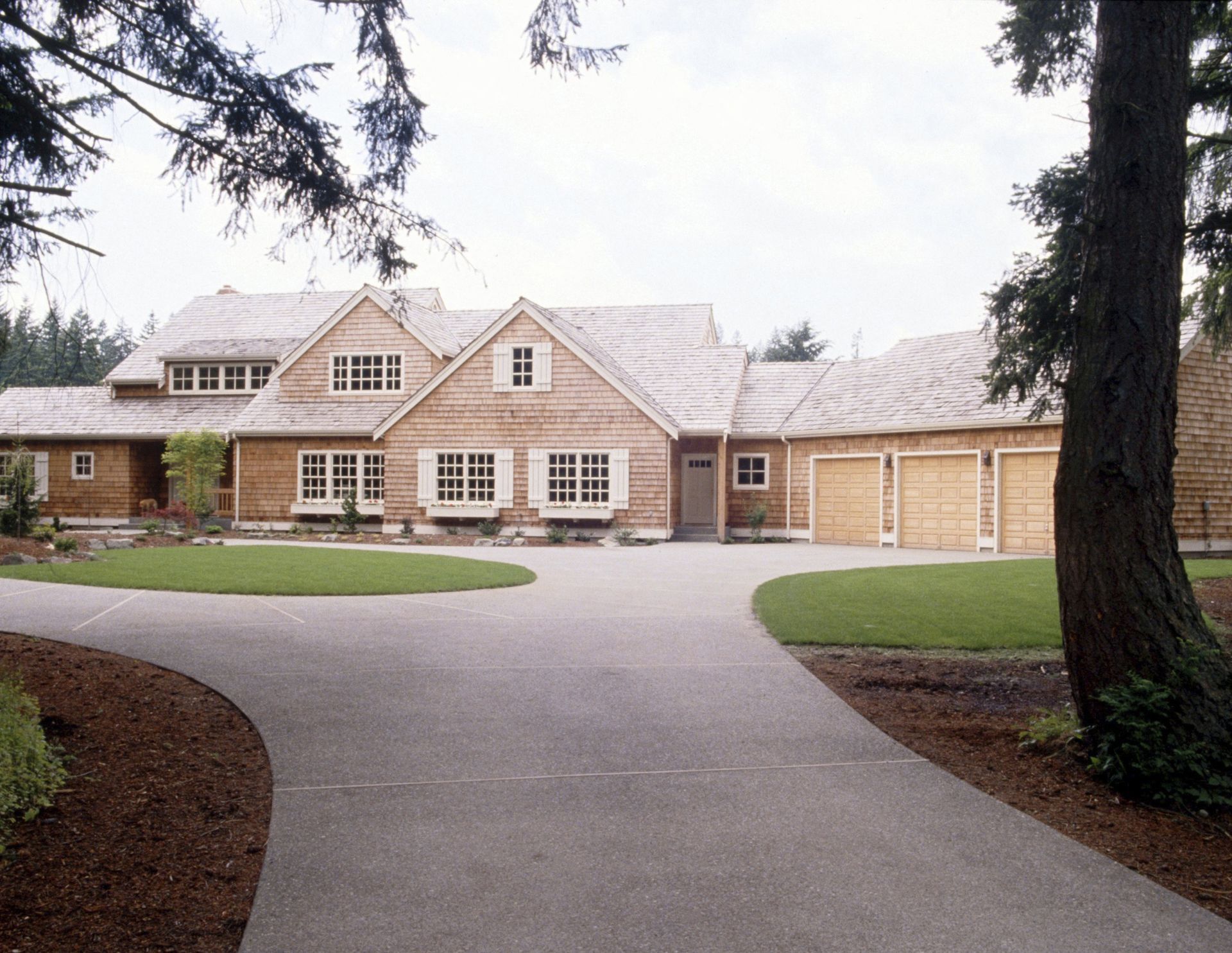A large house with a driveway leading to it
