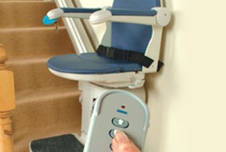 Someone operating a stairlift from a remote