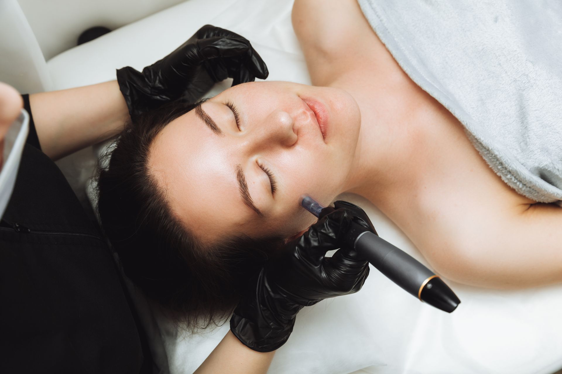 A woman is getting a facial treatment at a beauty salon.