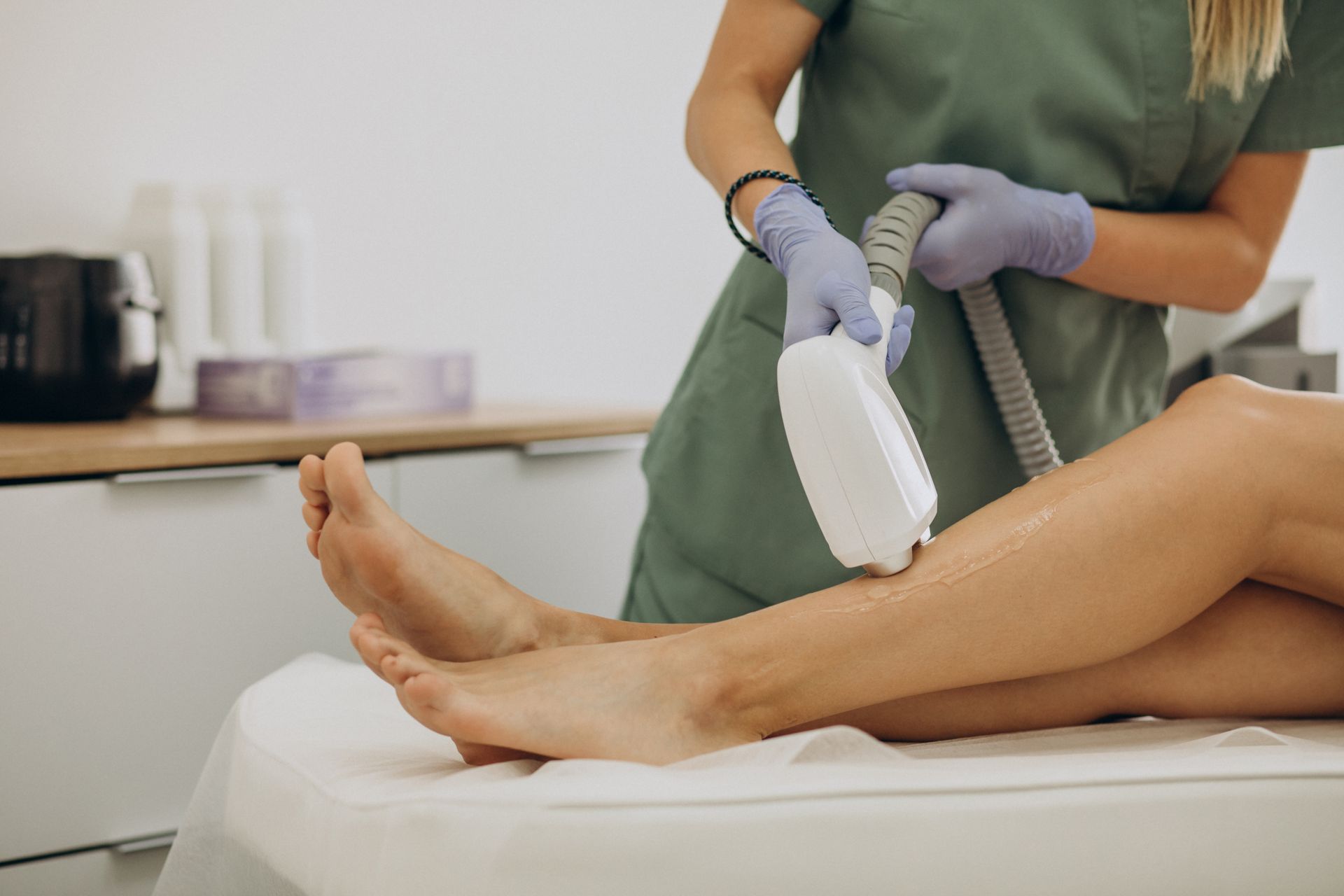 a woman is getting her legs waxed in a beauty salon .