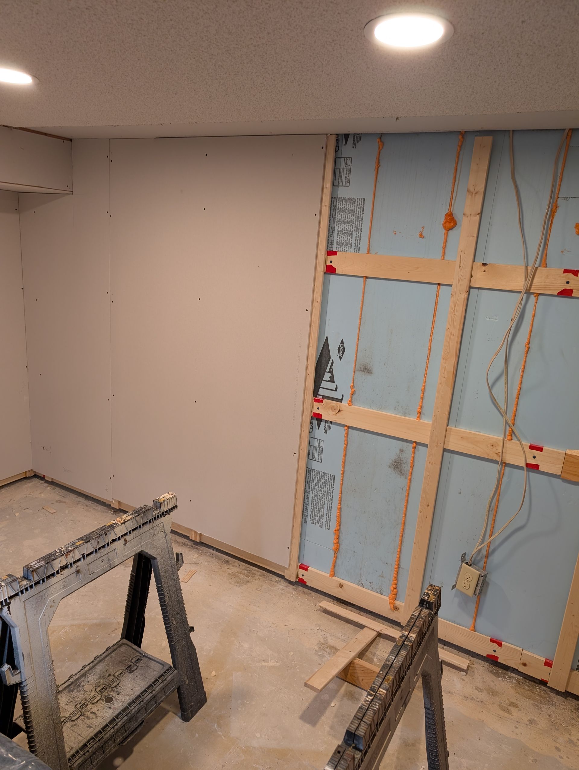 Basement wall framing against block
