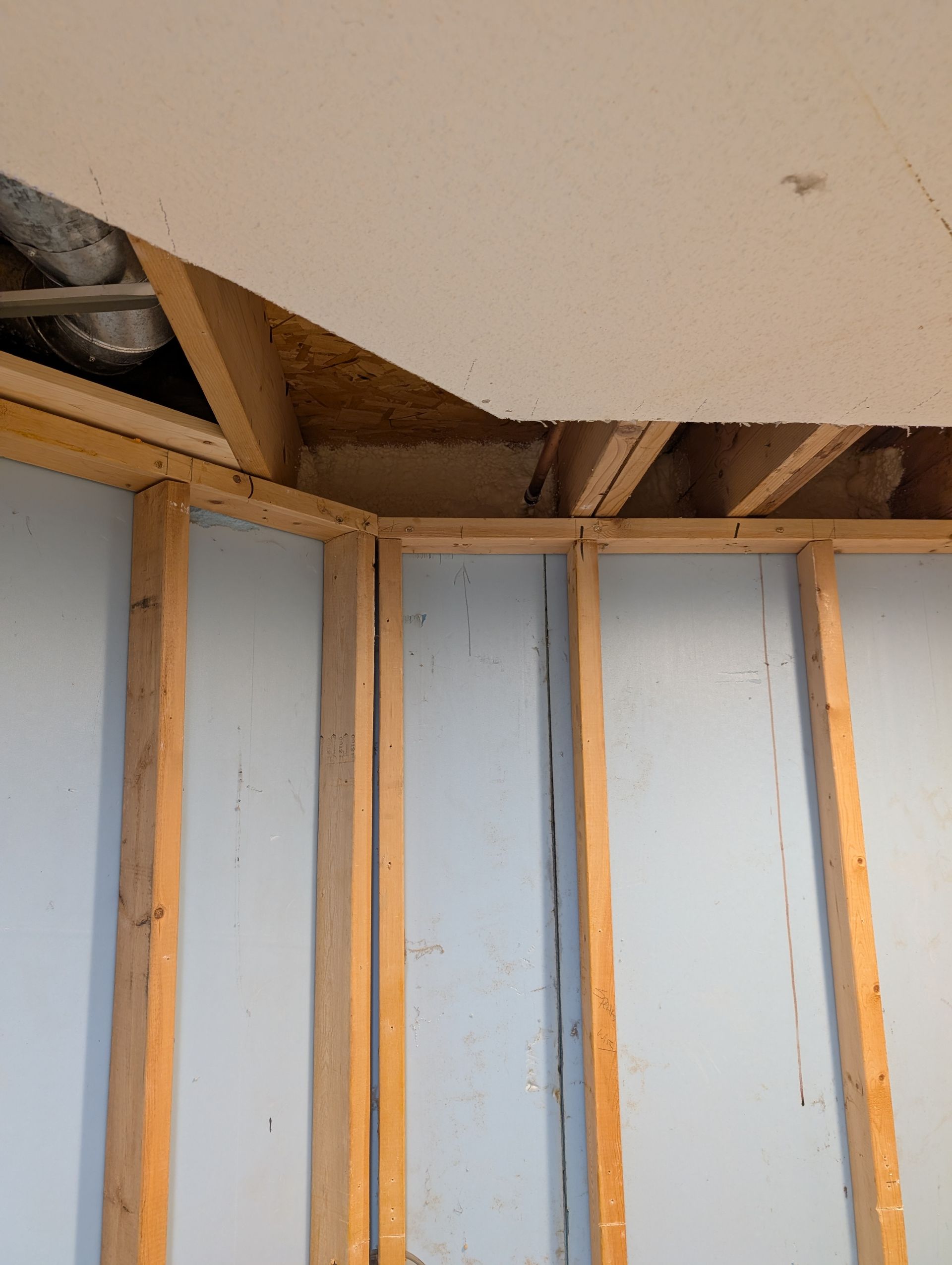 basement wall framing, cut out along the rim joist to spray foam