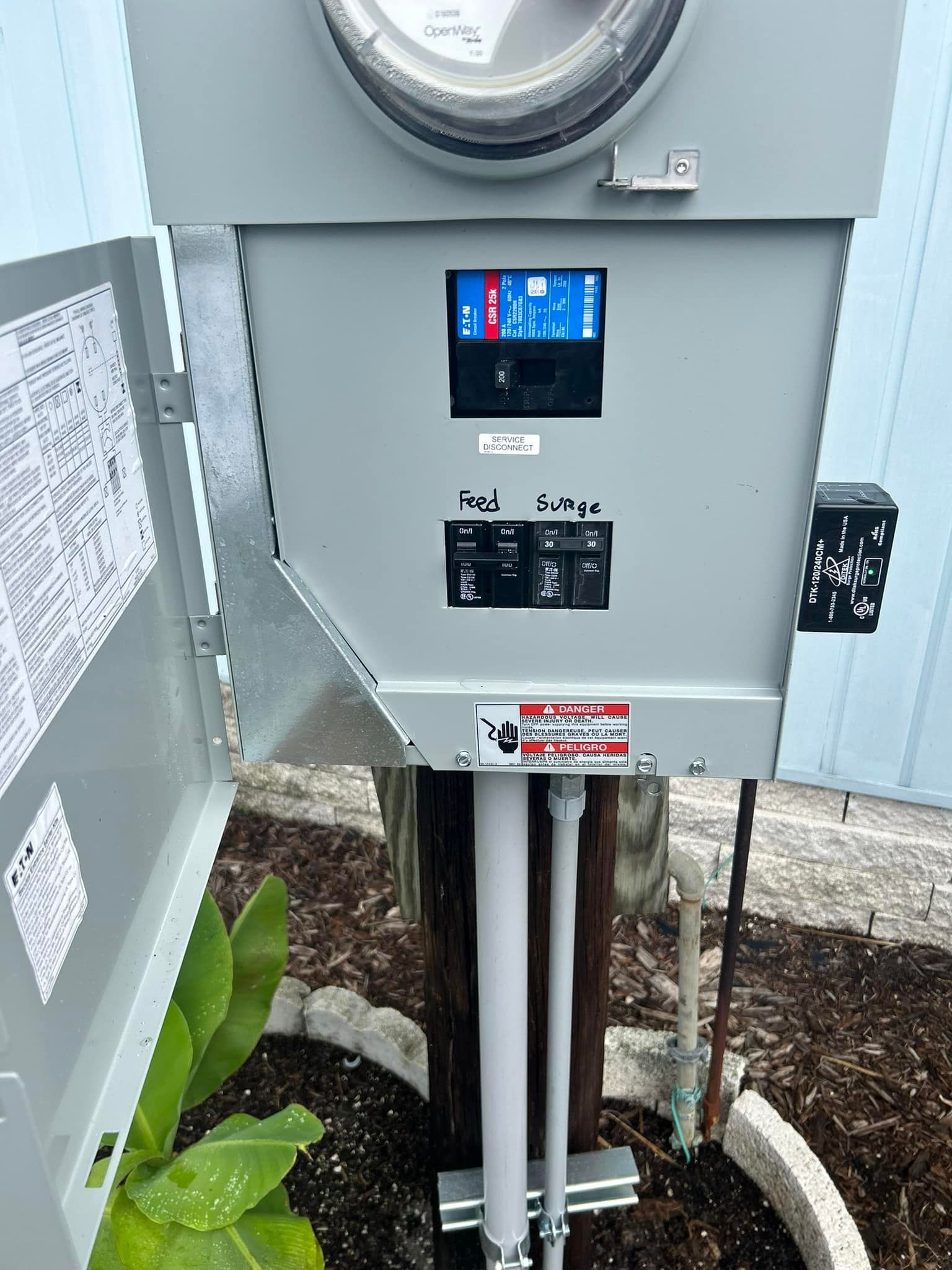 A Meter Is Sitting on Top of A Pole Next to A Potted Plant — Tarpon Springs, FL — Pinellas County Electric