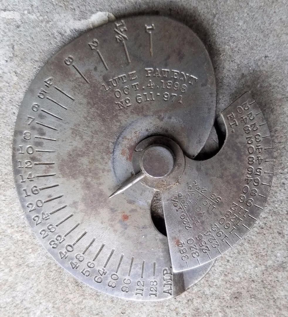 A Metal Object with Numbers on It Is Sitting on A Concrete Surface — Tarpon Springs, FL — Pinellas County Electric