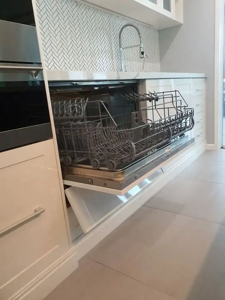 A Dishwasher Is Open in A Kitchen with The Door Open — JWB Joinery in Aitkenvale, QLD