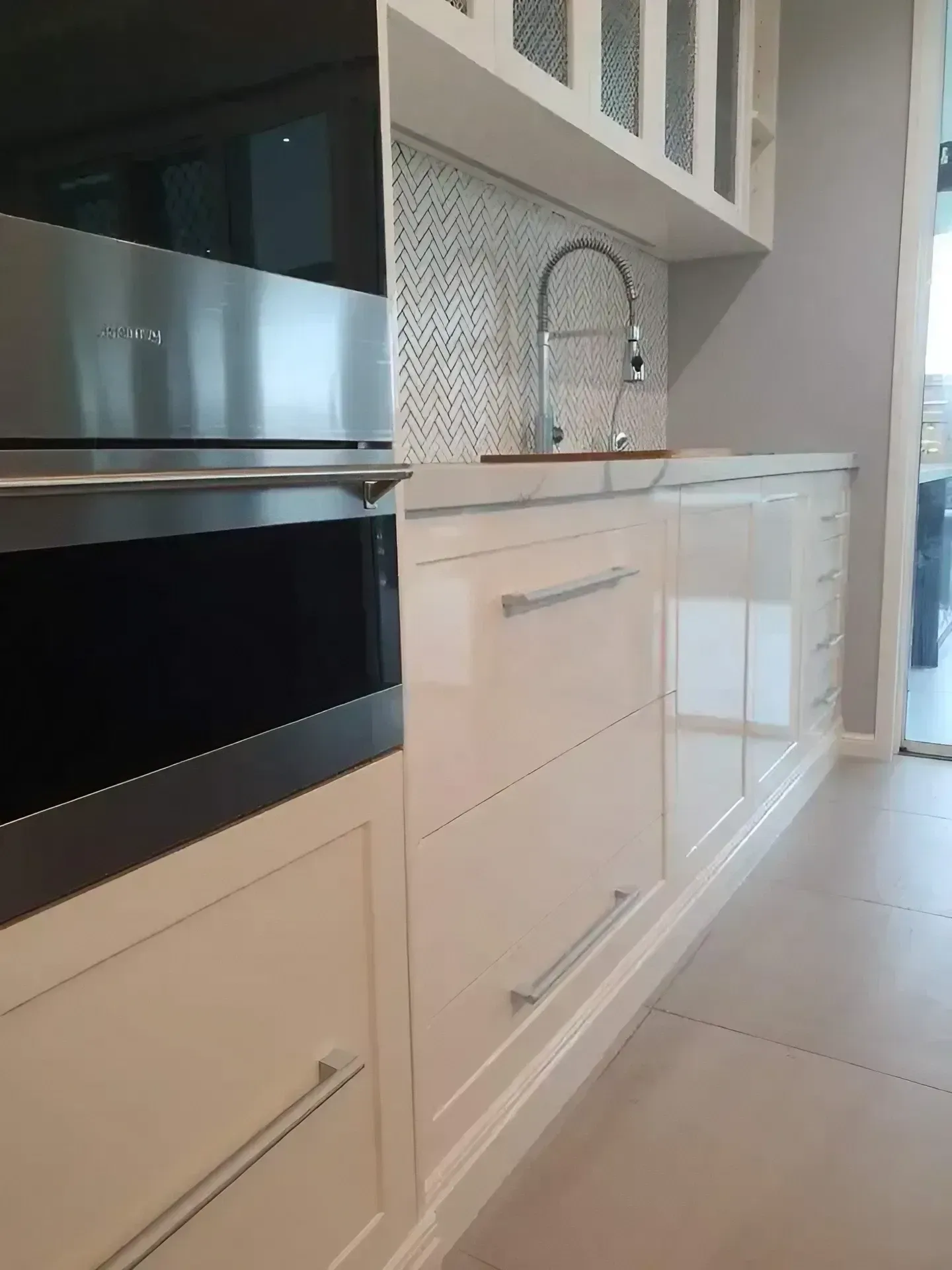 A Kitchen with White Cabinets , a Sink , and A Stainless Steel Oven — JWB Joinery in Aitkenvale, QLD