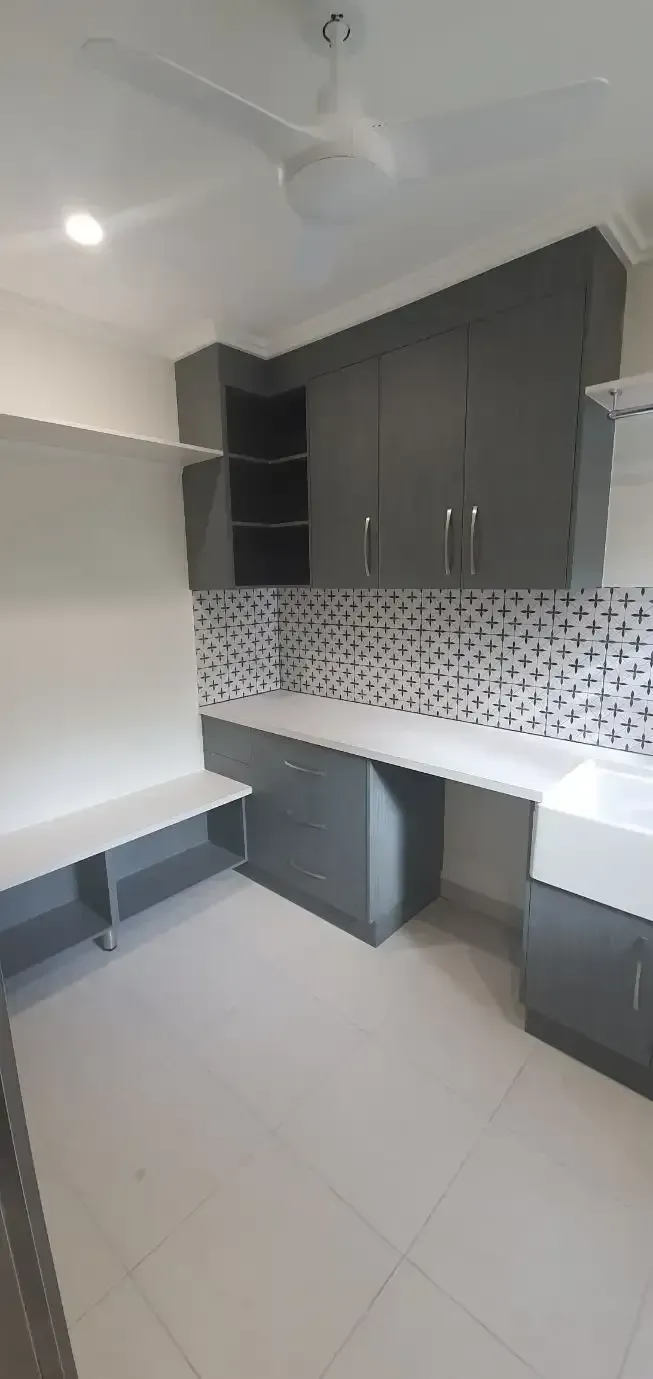 A Kitchen with Gray Cabinets, White Counter Tops, and A Ceiling Fan — JWB Joinery in Aitkenvale, QLD