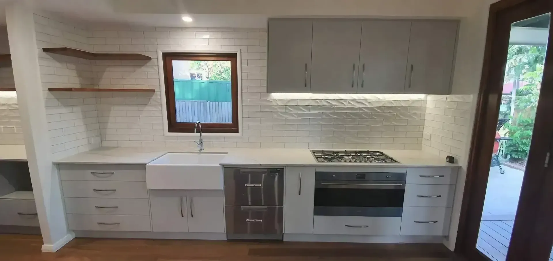 A Kitchen with White Cabinets, a Stove, a Sink, and A Window — JWB Joinery in Aitkenvale, QLD