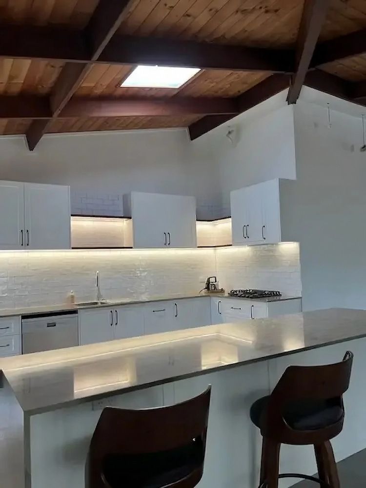 A Kitchen with White Cabinets and A Wooden Ceiling — JWB Joinery in Aitkenvale, QLD
