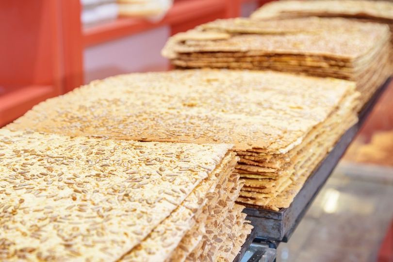 A stack of crackers on a shelf in a bakery.