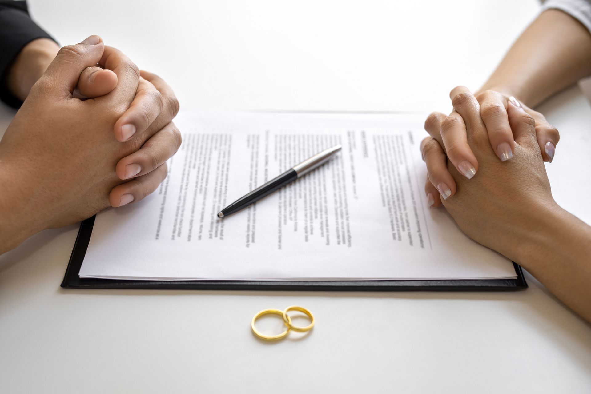 Divorce agreement and wedding rings.