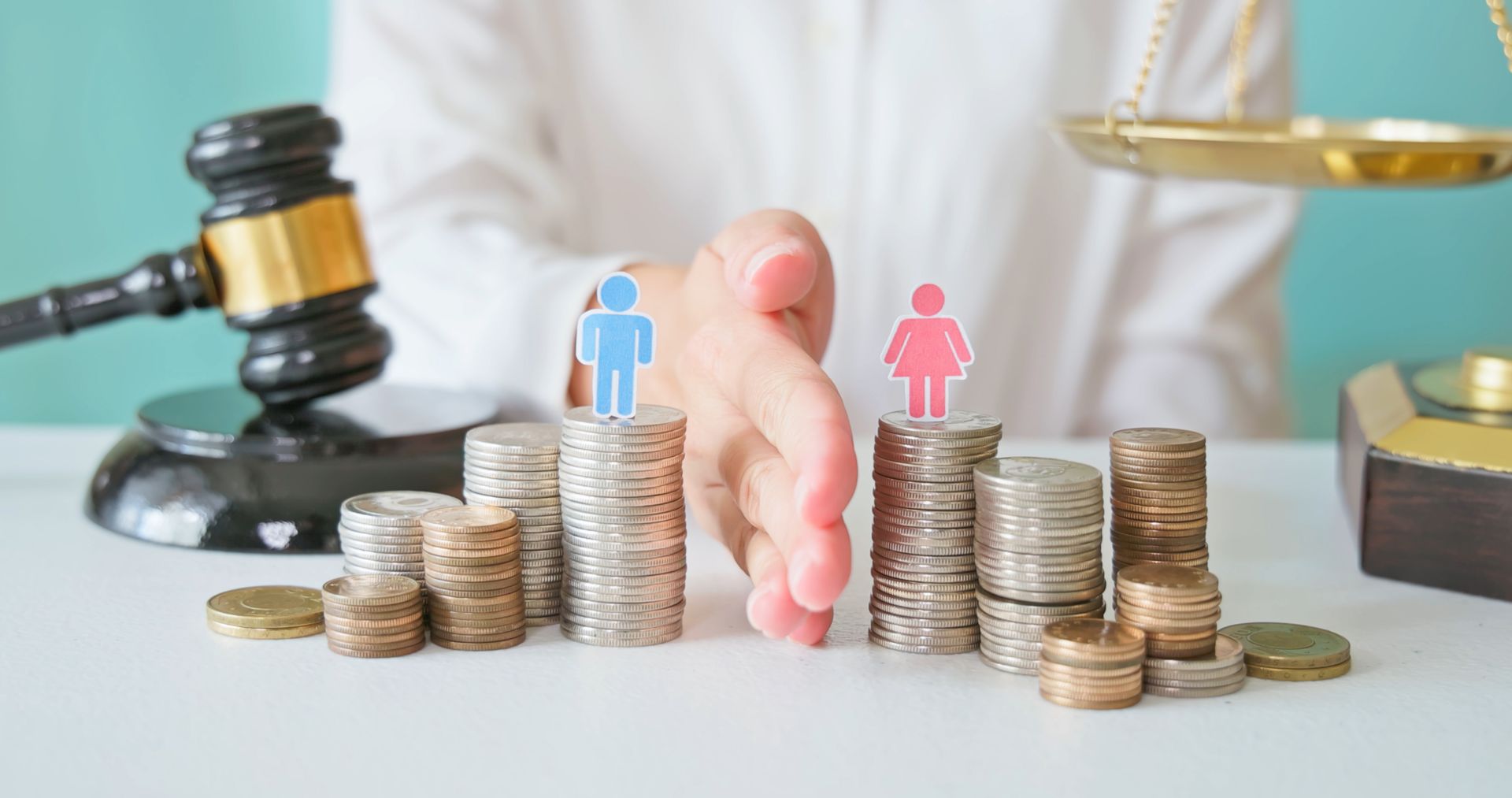 close-up of hands dividing coins into separate stacks symbolizing divorce and property division.